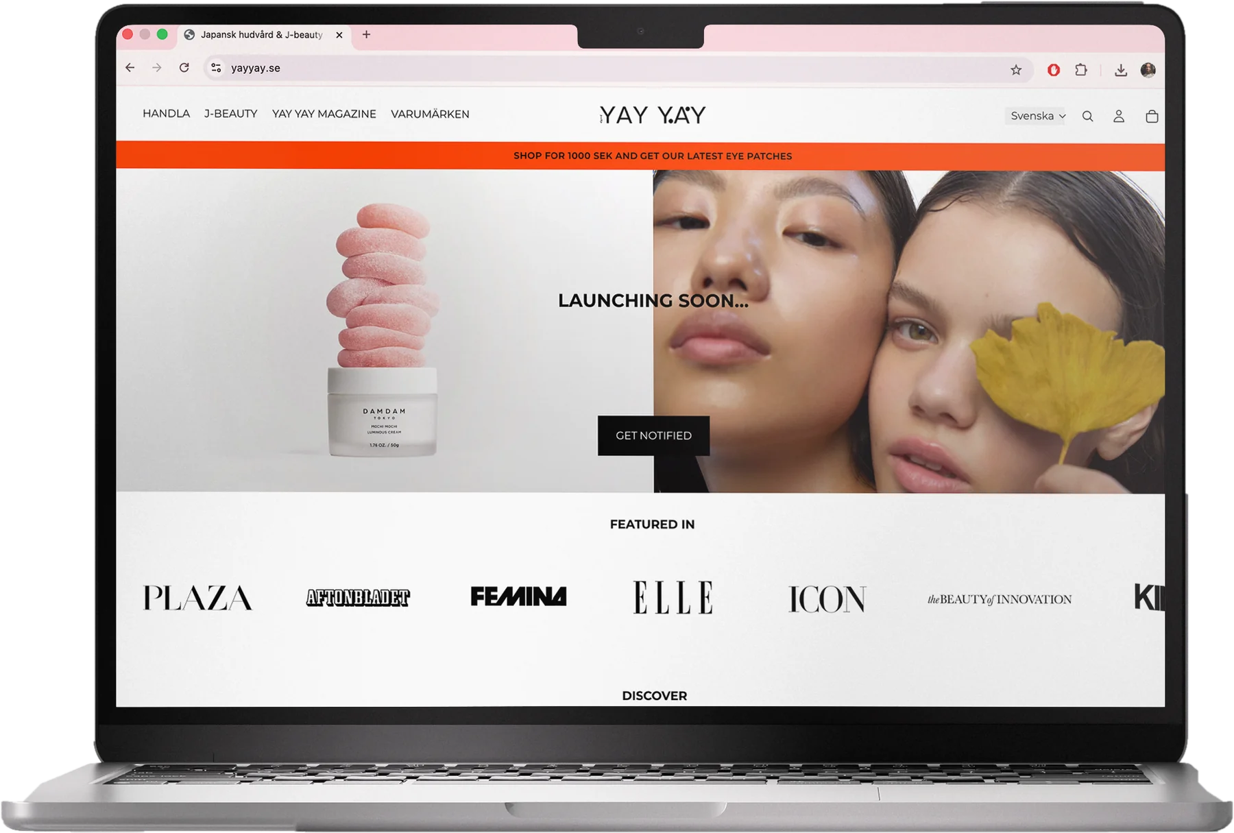 MacBook showing the YAY YAY home page: an orange campaign banner, a Launching soon hero with a product and two faces, and a row of press logos